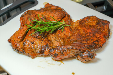 Marinated steak sliced in pieces with cilantro in a cutting board