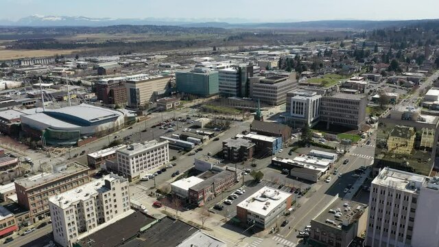 Cinematic drone clip of downtown Everett, XFINITY Community Ice Rink,  Angel of the Winds Arena surrounding suburbs, bedroom communities North of Seattle on the shores of Puget Sound in Washington