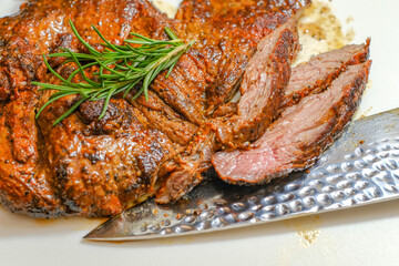 Marinated steak sliced in pieces with cilantro in a cutting board