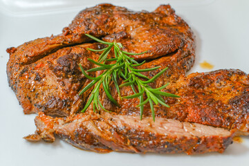 Marinated steak sliced in pieces with cilantro in a cutting board