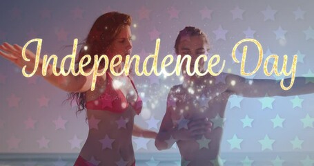 Independence day text over waving american flag against view of empty beach