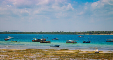 Wasini island, Kenya, AFRICA - February 26, 2020: Landscape view on ships and small boats on the water on wild island. It is the pure blue Indian Ocean.