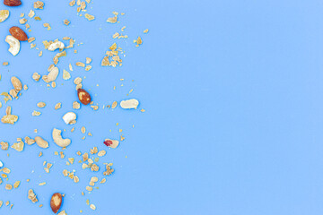 Top view granola healthy dessert bar Granola, cereal bars with nuts and berries, isolated on blue background with copy space