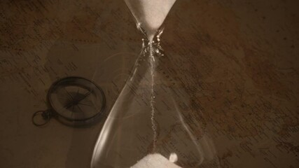 Animation of hourglass over vintage compass and world map - Powered by Adobe