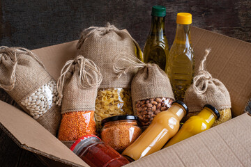 Volunteer with box of food for poor. Donation concept
