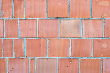 Closeup of perforated clay blocks. Red hollow bricks wall