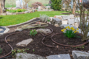 New garden bed with hoses for an irrigation system