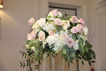 Close up of fresh flowers pink, white roses and candles arranged for the wedding celebration event