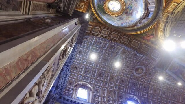 Indoor ceiling view of Basilica di San Pietro in Rome, Italy, beautiful gold finishing
