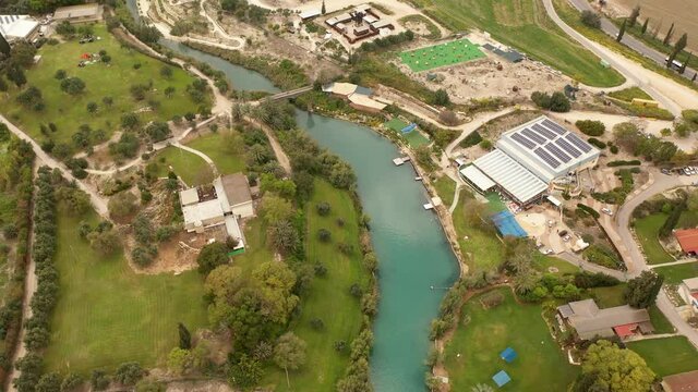 Small Town With Red rooftops CLose to River Channel in Israel, aerial view
Nir David kibbutz close to Beit shean valley  with river, Aerial view
