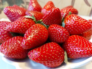 Ripe red large strawberries on a white background