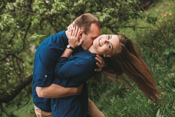 Portrait of a happy couple have fun in the spring garden. Strong family relationships of a couple in love