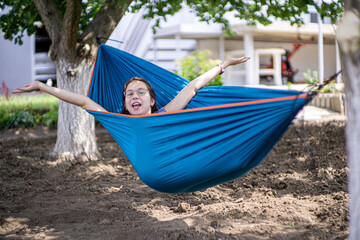 Beautiful pregnant girl smiling and being happy in a hammock