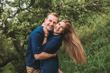 Fototapeta premium Portrait of emotional young couple hugging each other tightly, boyfriend and girlfriend, love you so much, strong affection in relationship