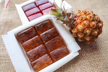 eco products. sweet dessert. natural jelly candies in a box and pineapple 