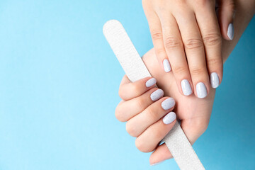 Manicure. Gray nails. Design - crumb on nails. Light fashionable manicure on female hands.