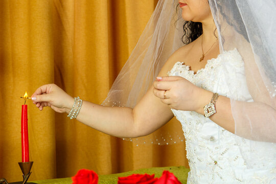 Before the chuppah ceremony, a Jewish bride lights candles.