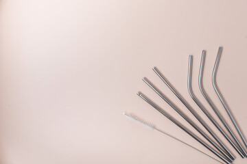 High angle view of six metal drinking straws arranged