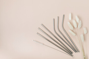 High angle view of six metal drinking straws arranged