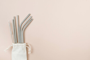High angle view of six metal drinking straws arranged