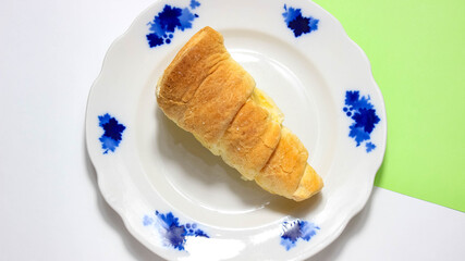 Puff pastry with protein cream on a plate.