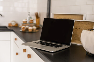 Modern and stylish laptop on a table in the kitchen