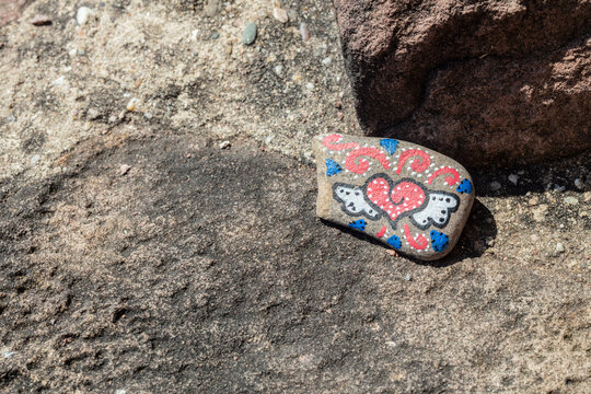 Herat with wings painted on a stone with copy space