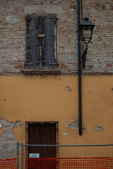 abandoned house with brick facades and closed windows, Italy