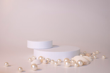 White podium on the white background with pearls and seashells. Podium for product, cosmetic...