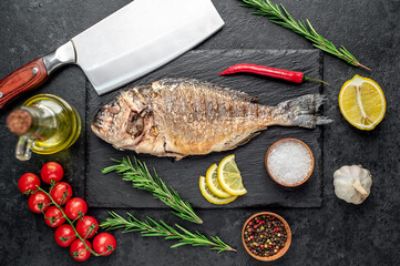 baked dorado fish on stone background