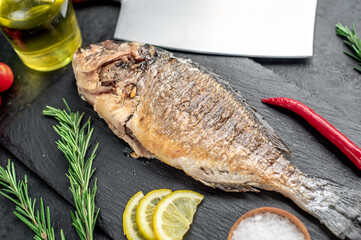 baked dorado fish on stone background