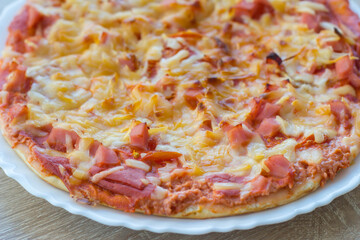 ham and cheese pizza sits on a white plate