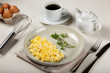 Breakfast with scrambled eggs on the table.