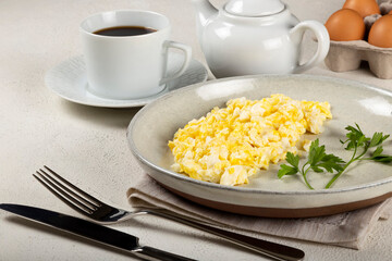 Breakfast with scrambled eggs on the table.