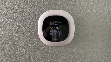 An Ecobee smart thermostat in a home.