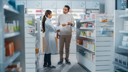 Pharmacy Drugstore: Female Asian Pharmacist Helping Indian Male Customer with Recommendation, and...