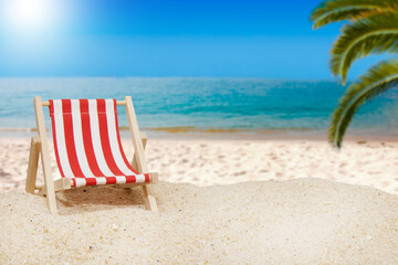 hammock on the sunny beach with palm tree