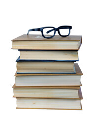 Eyeglasses on the top of the stack of books isolated on the white background