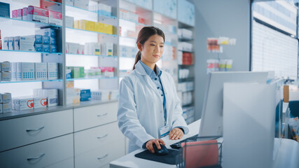 Pharmacy Drugstore: Beautiful Asian Pharmacist Uses Checkout Counter Computer, Does Inventory Checkup, Online Prescription of Medicine Packages, Drugs, Vitamin Boxes, Supplements, Health Care Products