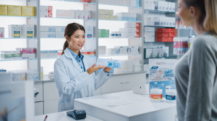 Pharmacy Drugstore Checkout Cashier Counter: Professional Asian Female Pharmacist Recommends...