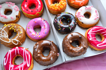 Delicious colorful donuts with different flavors and interesting decorations on the background