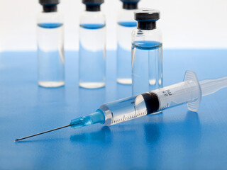 Close-up medical syringe and vials with medicine for injection