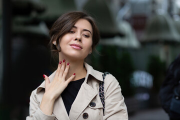 Elegant brunette woman wears trench