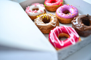 Delicious colorful donuts with different flavors and interesting decorations on the background
