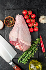 raw turkey leg with rosemary on stone background