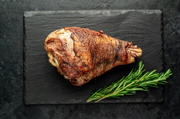 Baked turkey, turkey leg with rosemary on a stone background 