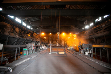 Large coal port. A car with coal is overturned in a closed coal transshipment building.