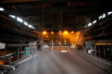 Large coal port. A car with coal is overturned in a closed coal transshipment building.