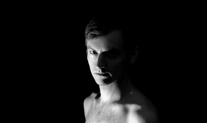 black and white photo portrait of a guy, in dramatic lighting