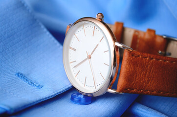 Men's luxury watch on a blue shirt. Watches for men